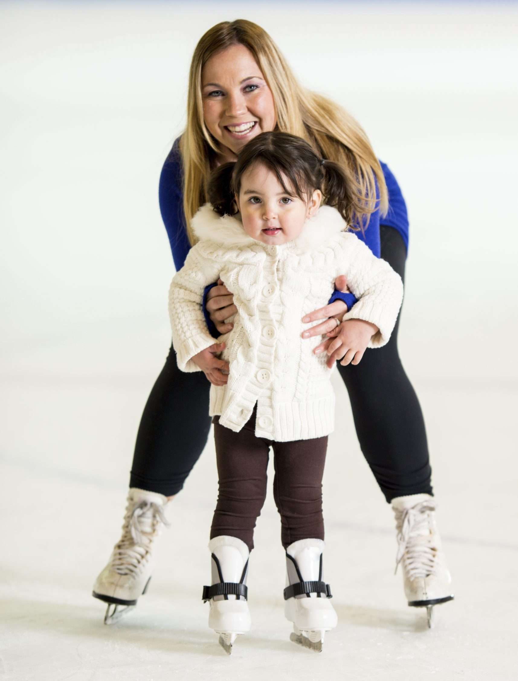 Mother and daughter ice skating
