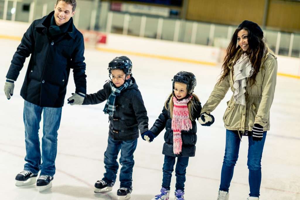 Having a good time at an ice skating arena.